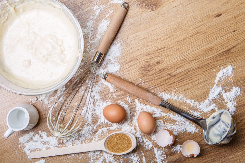 Baking ingredients and utensils on wooden surface. Baking ingredients and utensils on wooden surface.